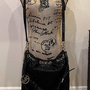 Michael Kors handbag. Lacquered black python-embossed purse. Gold-tone hardware.